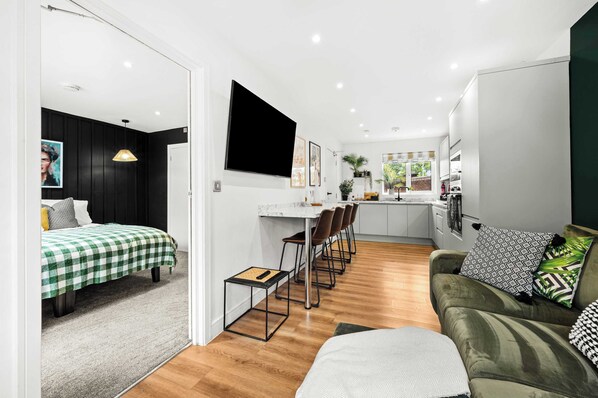 Un appartement moderne comprenant un coin repas, une cuisine et un espace de vie.