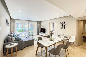 Scenic Pool Front 1 BDR @ Mangroovy | Free Pool & Beach (M1-6C-02_ | Living area | 55-inch Smart TV with satellite channels - Xuru Stays I Exotic 1bdr w/ Outdoor Terrace Pool & Beach Access (El Gouna)