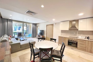 Waterfront & Groovy 2 BDR @ Mangroovy | Free Pool & Beach Access (M1-5A-03) | Living area | 55-inch Smart TV with satellite channels