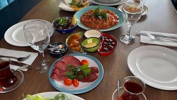A dining table set with various dishes, including salads, meats, and desserts, in a restaurant setting.