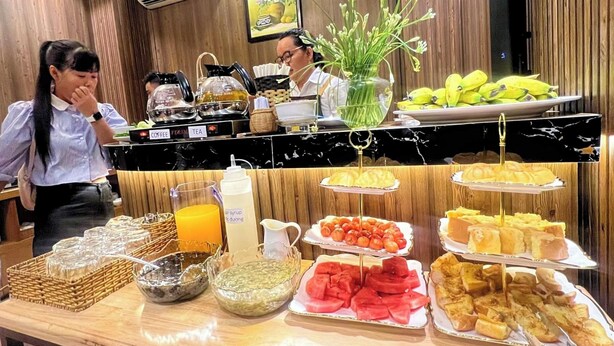 A buffet with various food items, including fruits, pastries, and condiments. - Rosa May Hotel (Ho Chi Minh City)