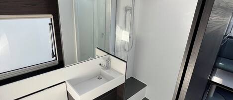 Shower, hair dryer, towels, toilet paper
