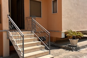 A staircase with metal railings leading to a building entrance.