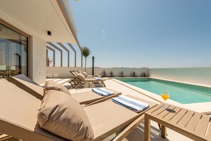 A modern outdoor pool area with lounge chairs and a glass-enclosed room. - Villa Mare Zadarvillas (Zadar)