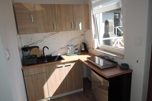 Fridge, stovetop, high chair, dining tables