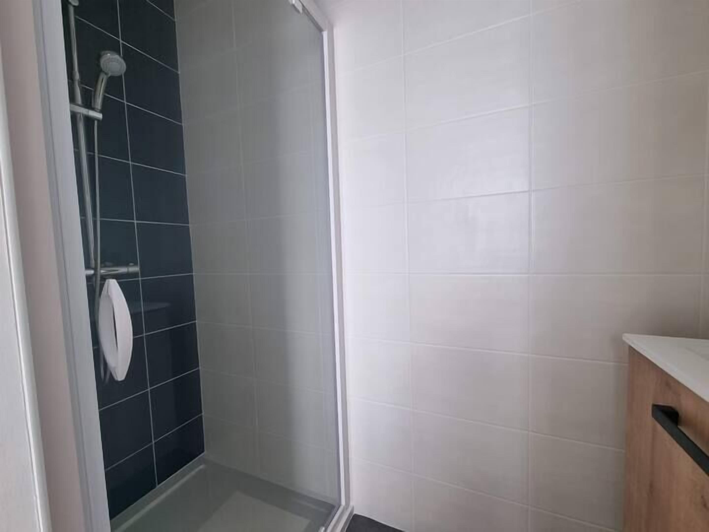 A bathroom with a shower, a toilet, and a sink.