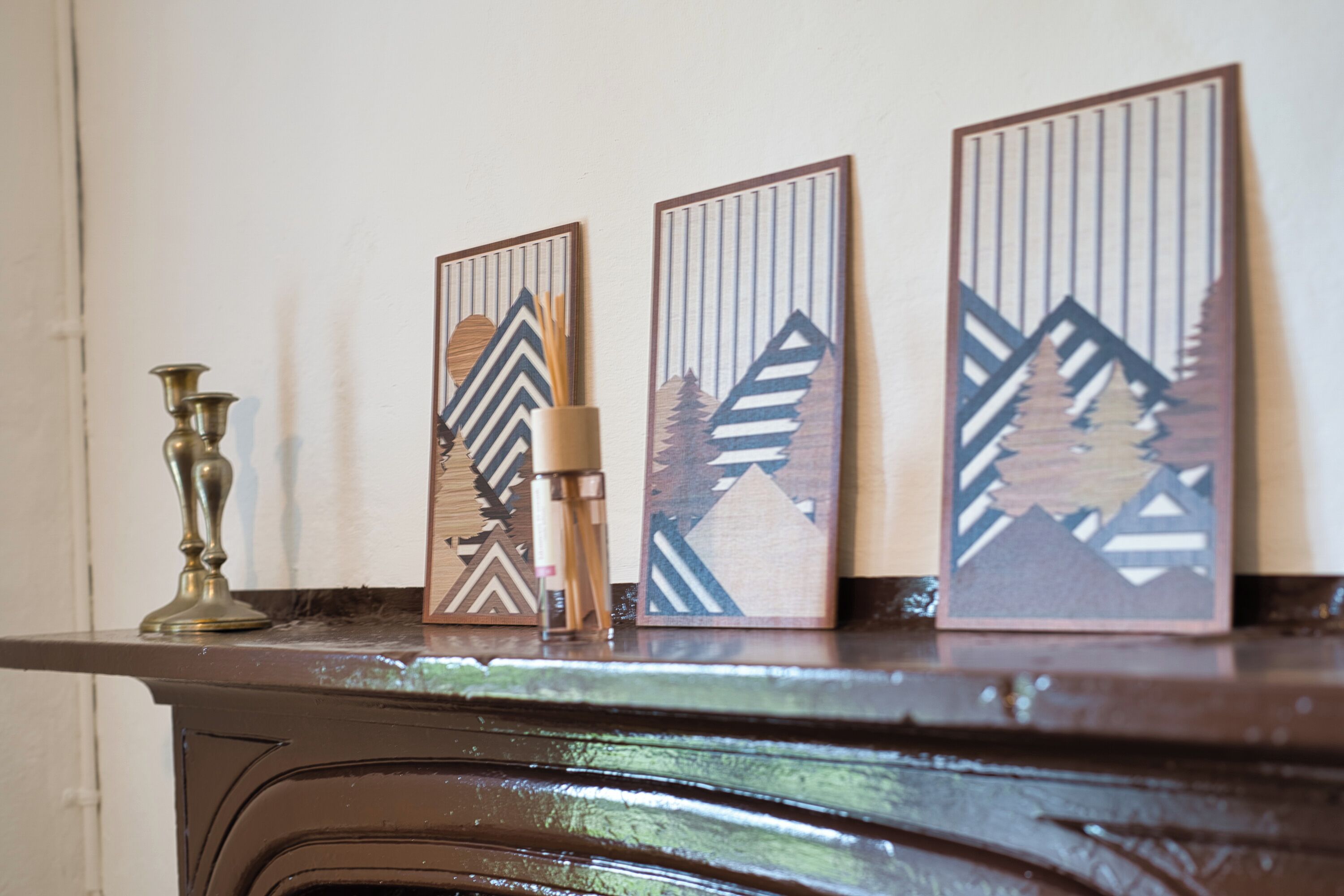 A fireplace mantel with decorative panels and a candelabra.