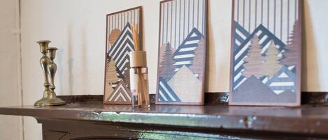 A fireplace mantel with decorative panels and a candelabra.