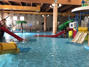 An indoor water park with slides and a pool. - Top-floor Corner escape at Bridges Bay: 3BR/2BA + WATERPARK PASSES INCLUDED (Arnolds Park)