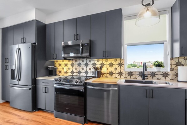Condo, 1 Queen Bed with Sofa bed, Balcony (Creekside Modern) | Private kitchen | Fridge, microwave, oven, stovetop