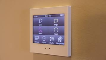 A digital control panel for a hotel room with options for temperature, lighting, and room settings.