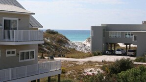 A coastal building with a balcony, a parking area, and a view of the ocean. - Coastal Fave- Lrg Private Pool + 2 Min Beach Walk (Santa Rosa Beach)