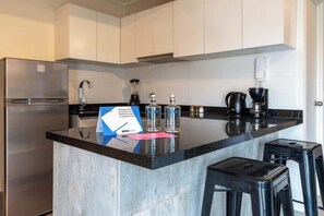 A modern kitchen with a stainless steel refrigerator, a coffee maker, and a blender on the counter. - Geko | Stylish Loft w/AC near Malecón de Barranco (Barranco)