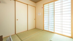 A traditional Japanese room with tatami flooring, sliding doors, and a large shoji screen window. - Japanese-style family house in the western of Tokyo, DP Oyamamachi　 (町田市小山町)