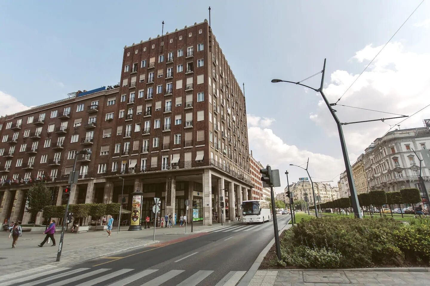 A multi-story hotel with a prominent entrance, large windows, and a central courtyard.