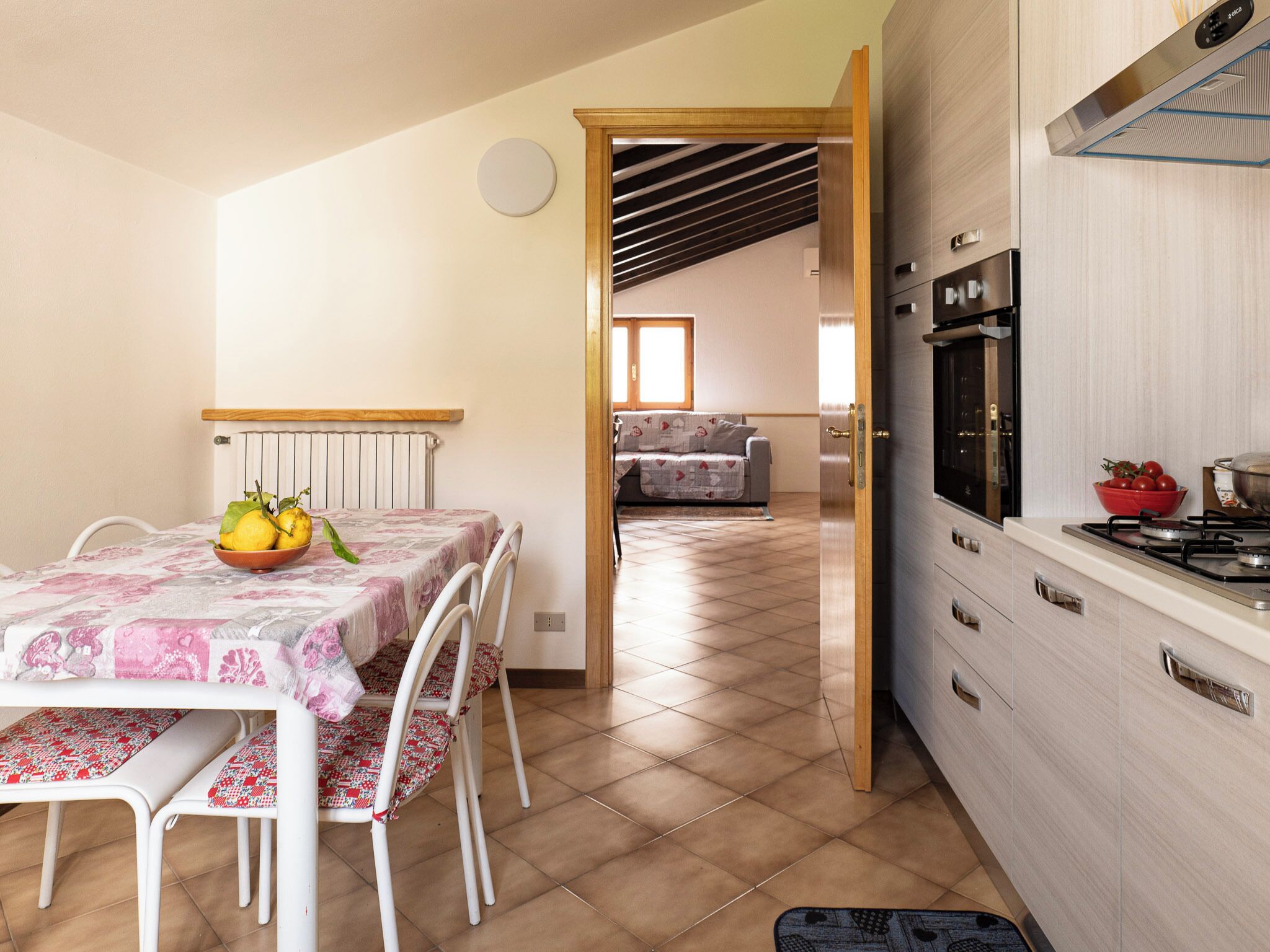 A kitchen with a stove, oven, and a dining area with a table and chairs.