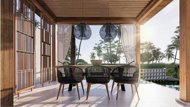 A covered outdoor seating area with a table and chairs, overlooking a pool and palm trees. - Villa Rizière Ubud Center (Bali)