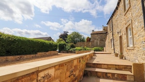 A stone building with a stone pathway leading to a set of steps. - Rowan Tree Cottage (Skipton)