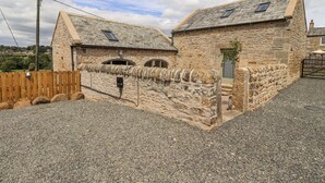 A stone building with a gravel driveway, a wooden fence, and a small gate. - West Dunkirk Hemmels (Hexham)