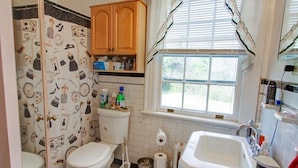 Ein Badezimmer mit Toilette, Waschbecken und Fenster.
