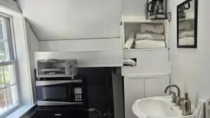 A compact kitchen with a microwave, coffee maker, and sink. - Charming B&B with AC, WiFi in Phenomenal Revere (Revere)
