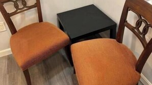 Two wooden chairs with cushioned seats and backs, positioned on a wooden floor against a white wall. - Charming B&B with AC, WiFi in Phenomenal Revere (Revere)