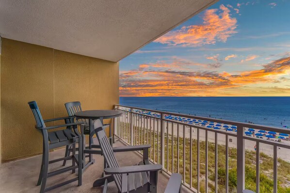 A balcony with a view of the beach and sunset. - Sunset Views, Beachfront & Resort Pools (Panama City Beach)