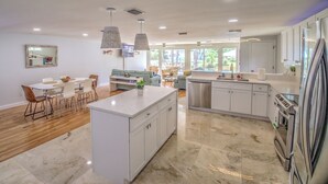 A modern kitchen with white cabinets, a large island, and stainless steel appliances. - New Listing! Dockside Palms Weeki Wachee-Spring Fed Canal-Boat Friendly!  (Spring Hill)