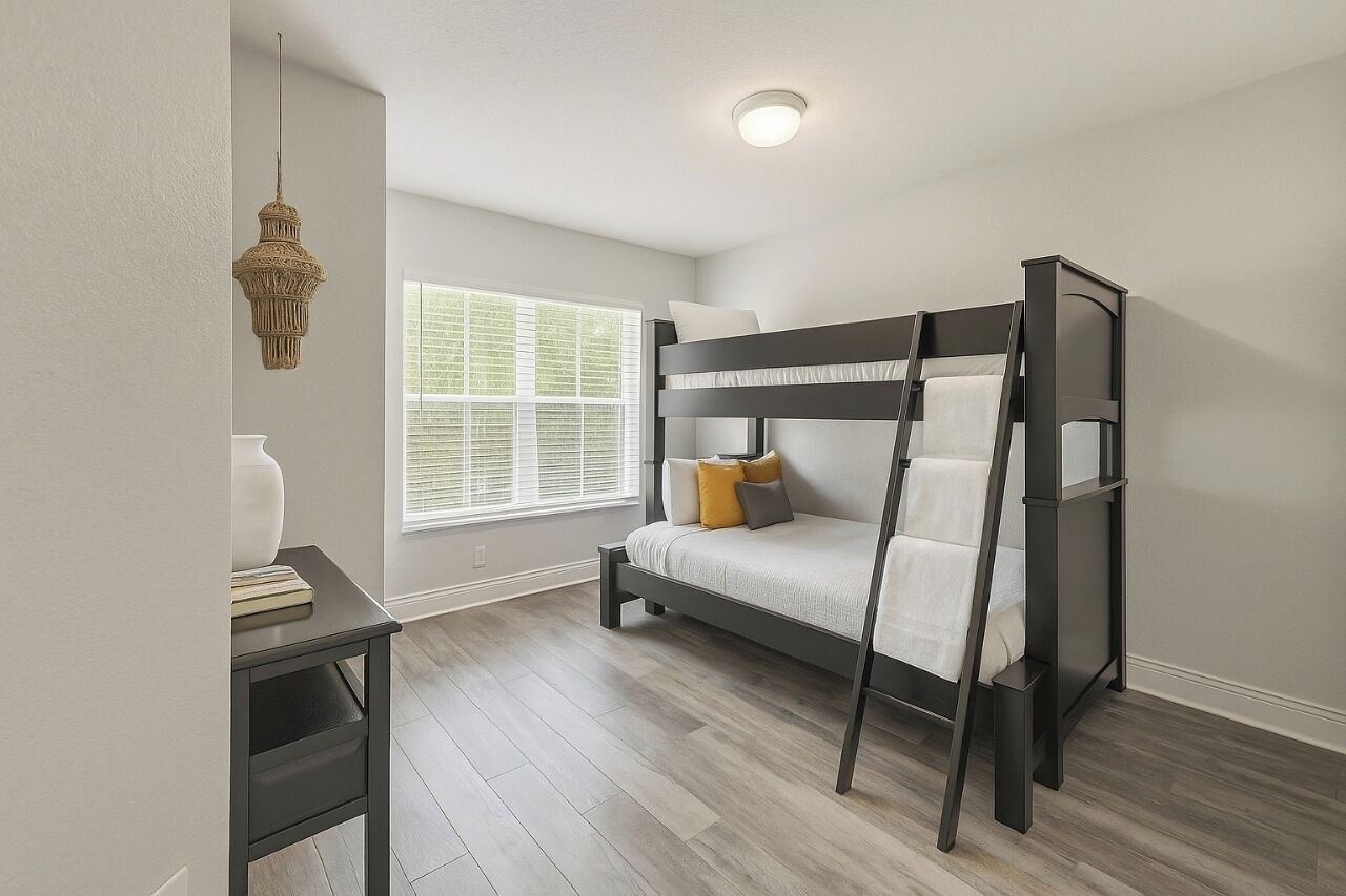 A bunk bed in a room with a window, a bedside table, and a hanging light fixture.