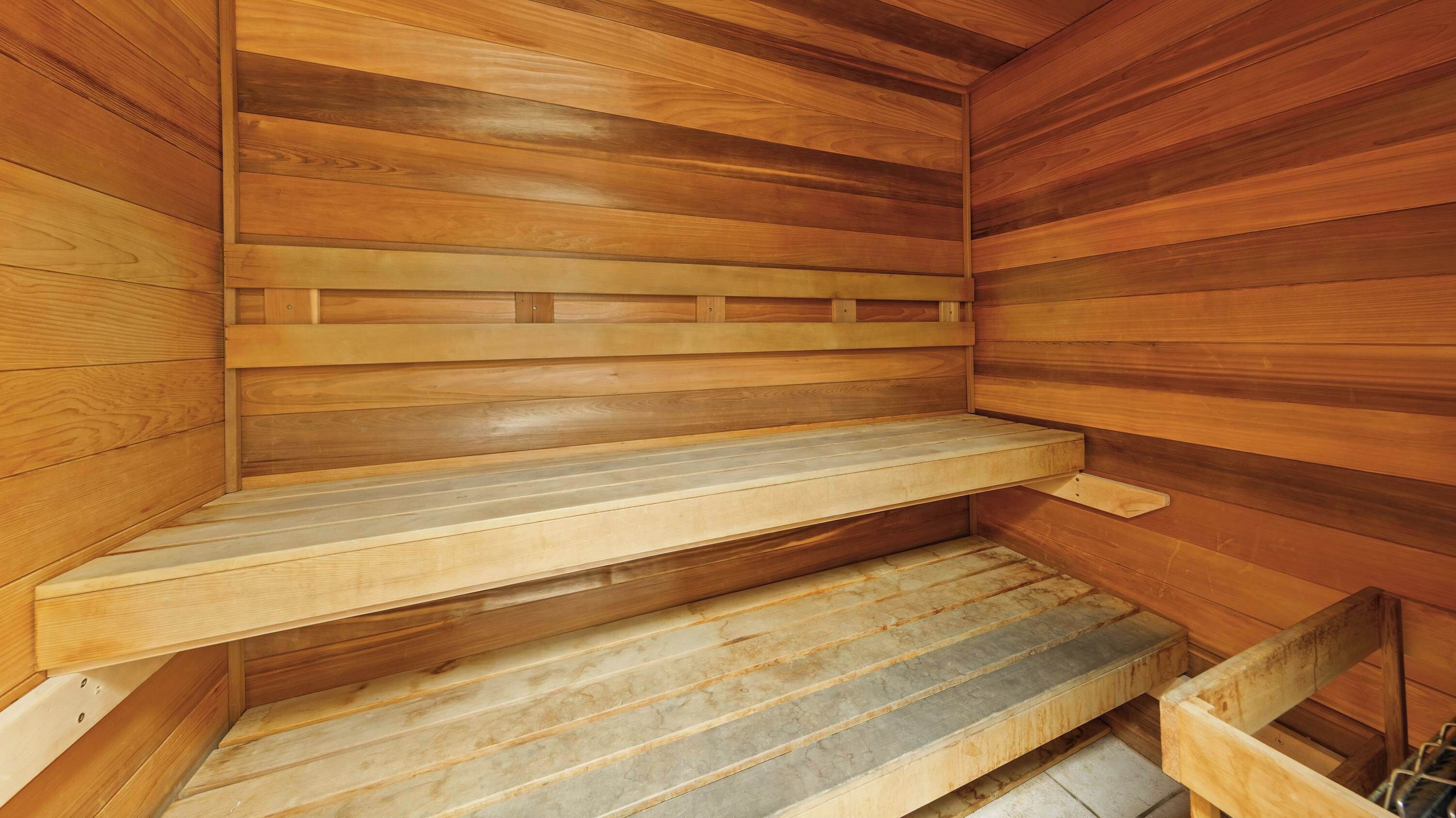 A sauna with wooden walls and benches.