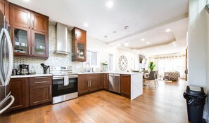 Une cuisine moderne avec des meubles en bois, des appareils en acier inoxydable et un îlot central.