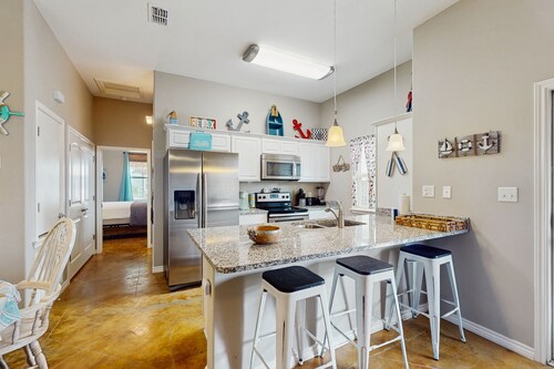 Coastal, dog-friendly townhouse with shared pool & large yard - steps to sand