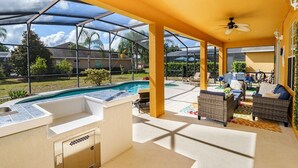 A covered outdoor area with a pool, seating, and a grill. - Luxury 2850sf Rental | Water + Conservation Views | Near Clubhouse | Gated (Davenport)