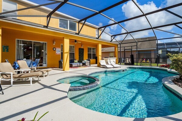 A pool area with lounge chairs and a covered patio. - Luxury 2850sf Rental | Water + Conservation Views | Near Clubhouse | Gated (Davenport)