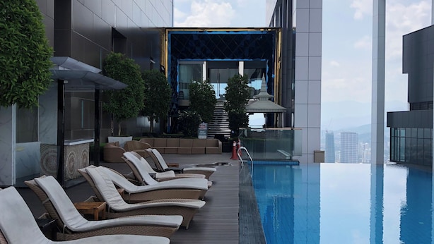 A modern rooftop pool area with lounge chairs and a clear view of the city skyline. - Platinum Suites Kuala Lumpur by Skyline (Kuala Lumpur)