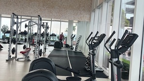 A gym with various exercise equipment, large windows, and a high ceiling. - Platinum Suites Kuala Lumpur by Skyline (Kuala Lumpur)