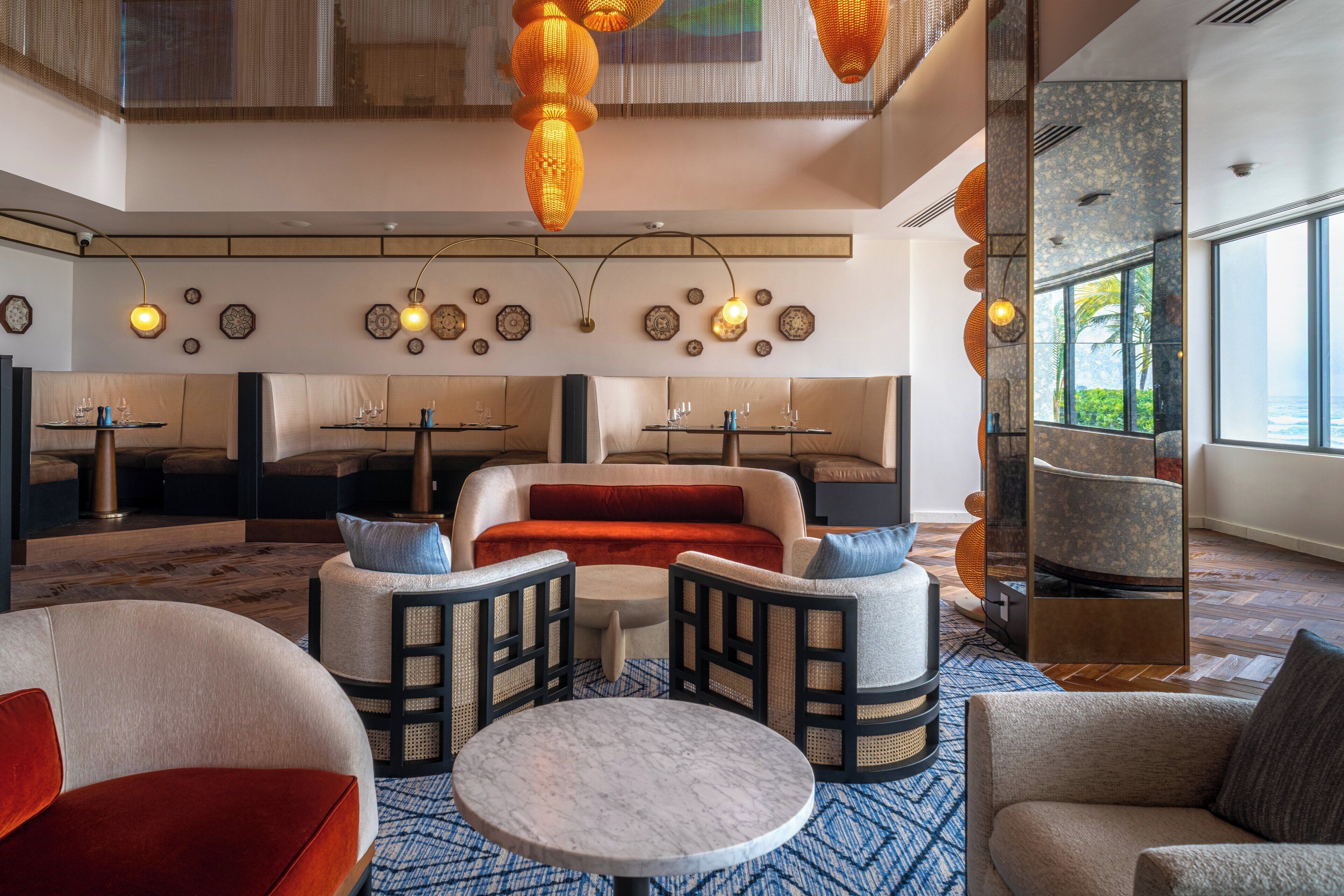 A spacious lobby with seating areas, a large round table, and a view of the outdoors.