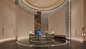 A spacious lobby with a curved ceiling, a central reception desk, and a polished floor. - Intercontinental Changchun High Tech Zone by IHG (Changchun)