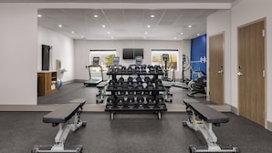 A gym with weightlifting equipment, treadmills, and exercise machines. - Holiday Inn Express And Suites Huntsville Northeast by IHG (Huntsville)