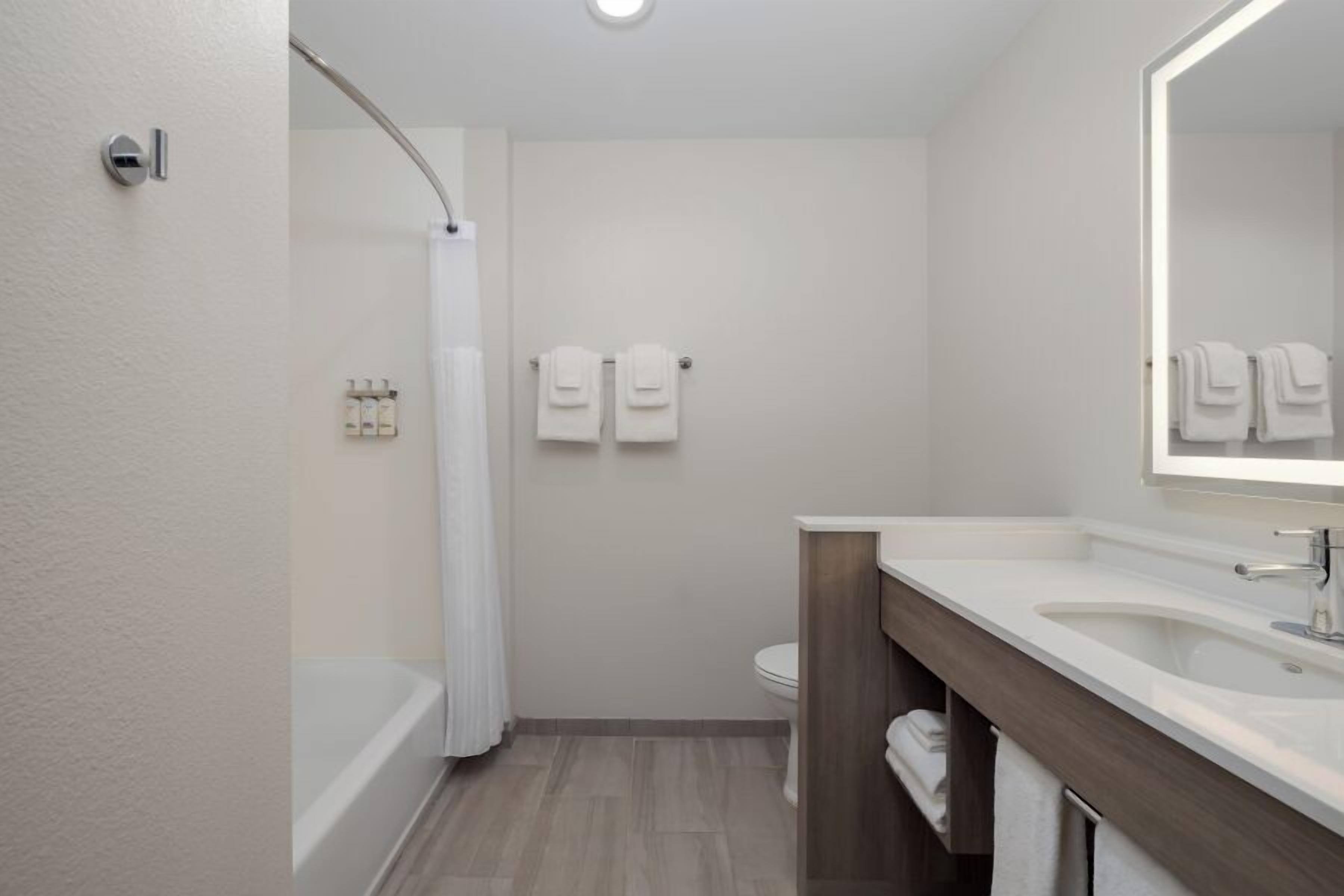 A modern bathroom with a bathtub, a toilet, and a sink.