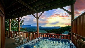 A hot tub under a wooden pergola with a view of mountains. - Luxe Cabin w/ Breathtaking Smoky Mountain Views (Sevierville)