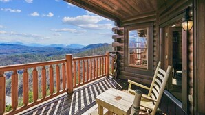 A wooden cabin with a balcony overlooking a mountainous landscape. - Luxury Mountain Cabin w/ Hot Tub & Views (Sevierville)