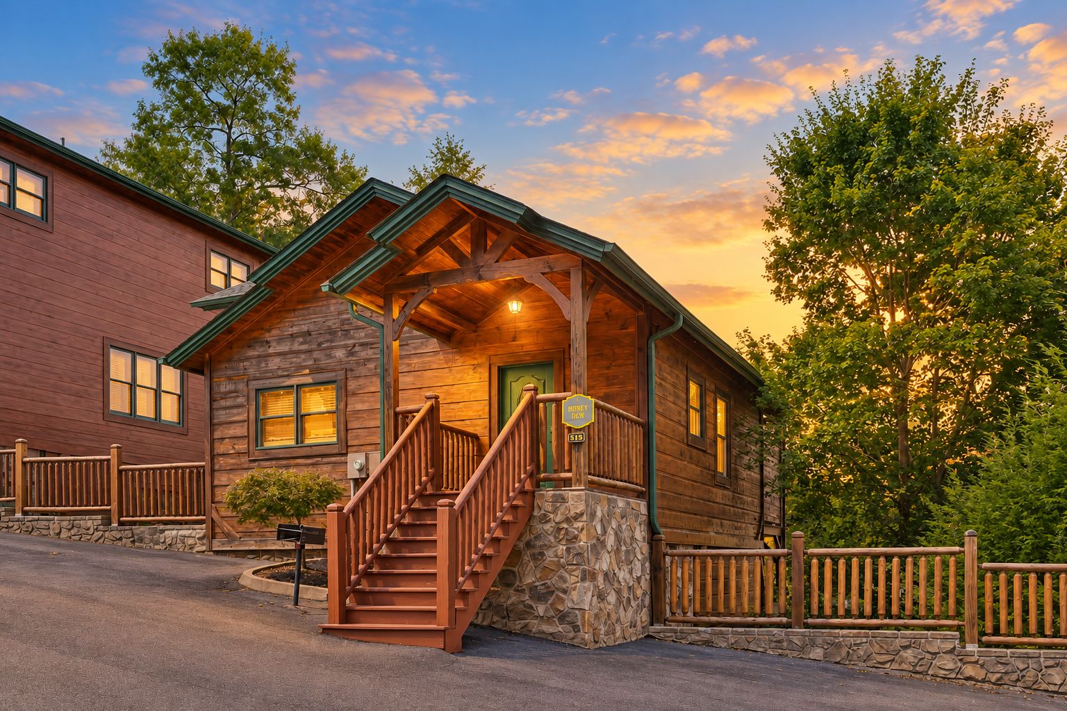 A log cabin with a stone foundation, a wooden staircase, and a porch with a green roof.