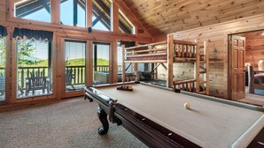 A wooden interior with a pool table, large windows, and a balcony. - Smoky Mountain Charm w/ Hot Tub & Views (Sevierville)