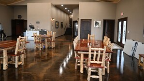 A spacious dining area with rustic wooden furniture and a polished floor. - Our beautiful lodge near Albany, MO is sure to please! Perfect for large groups (Albany)