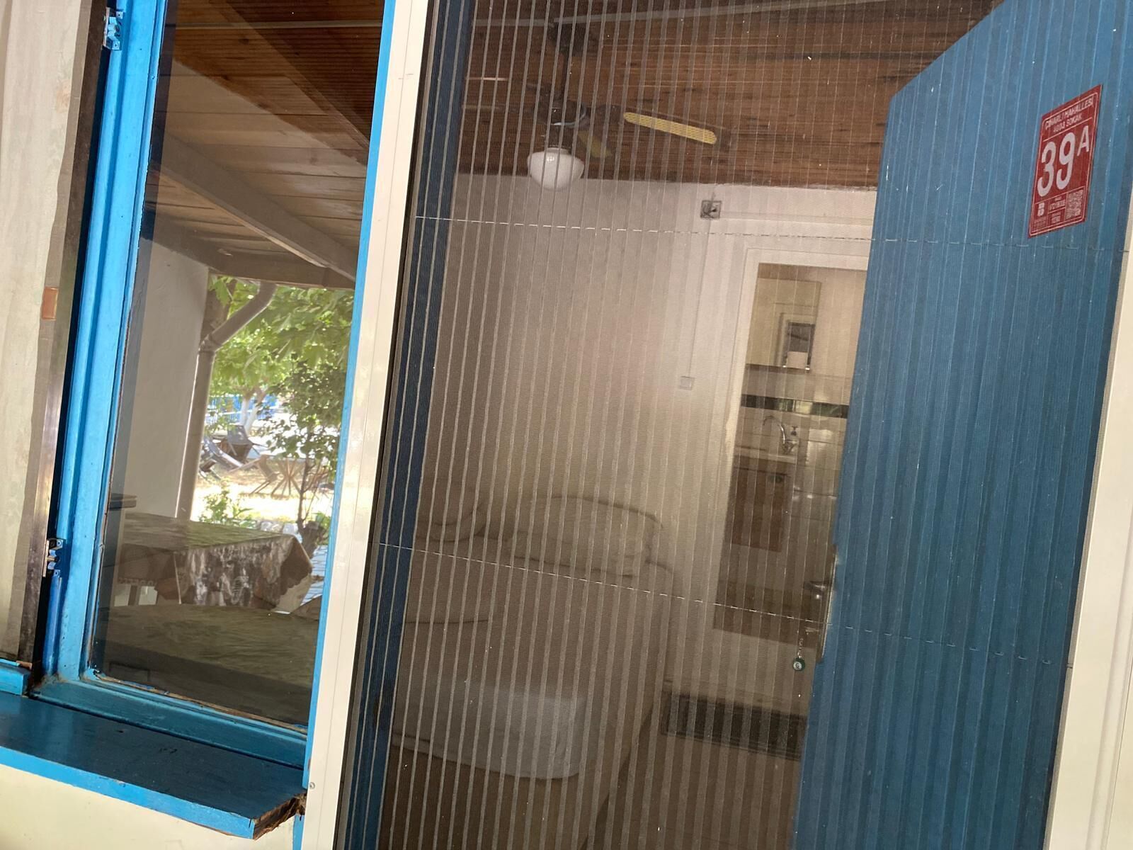 A room with a window, a door, and a sign indicating room number 39A.