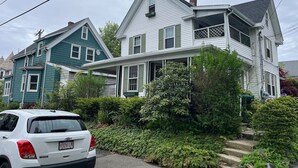 A two-story house with a porch and a car parked in front. - Swampscott! Walk Dtwn and beach (Swampscott)