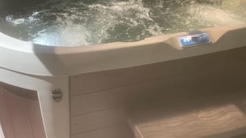 A hot tub with a control panel and a card reader.
