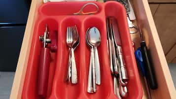A kitchen drawer with utensils and cookware.
