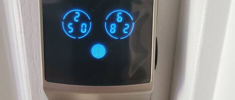A digital keypad lock with a heart-shaped keyhole.
